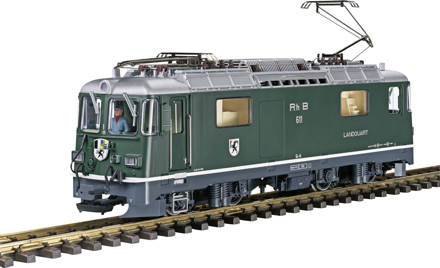 Un treno verde con la scritta 'RhB 611 LAUD/VAULT' sta percorrendo un binario. Una persona è visibile nella cabina di guida.