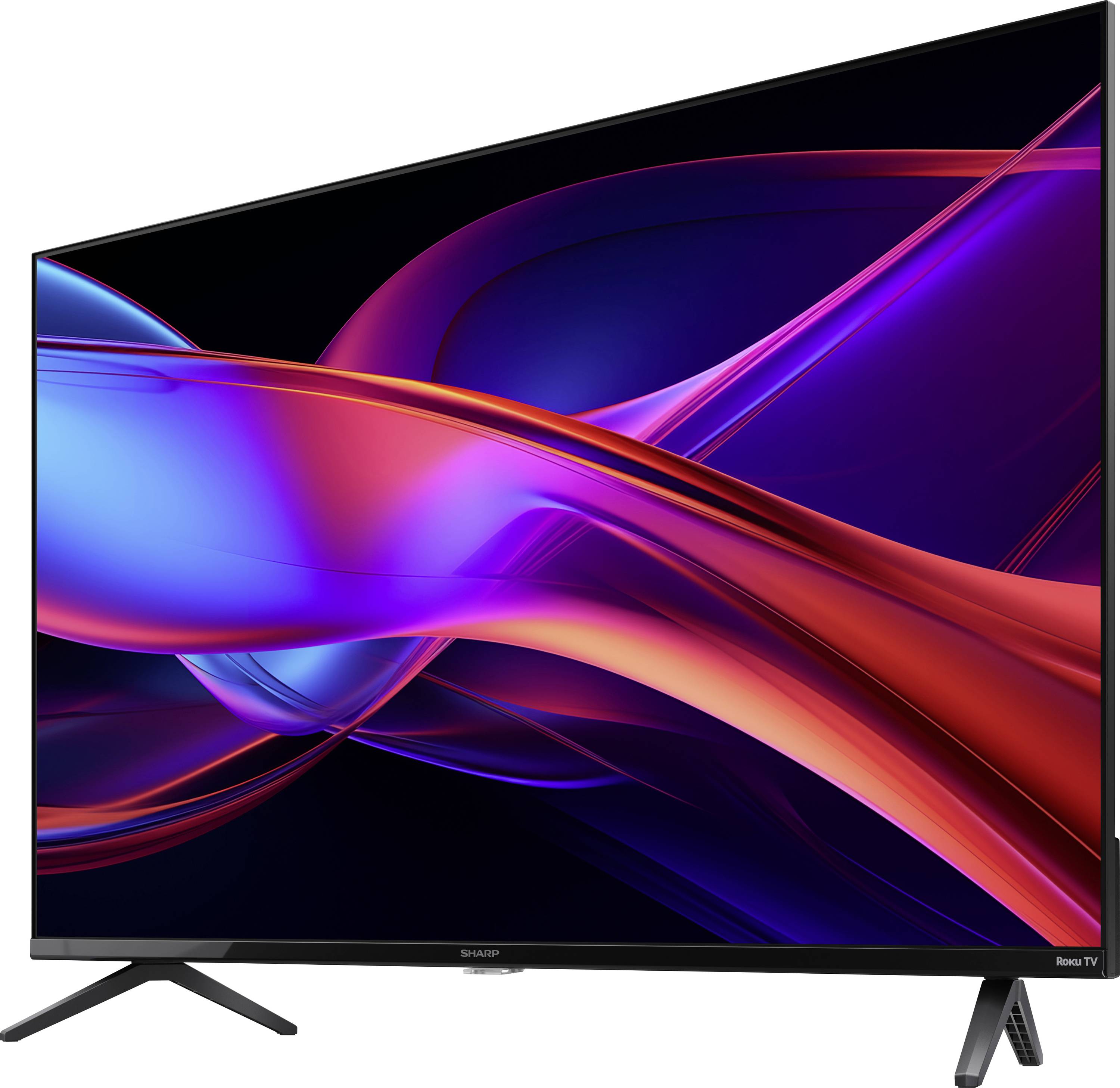 Un televisore elegante con schermo piatto, con un display vivace e multicolore che presenta linee curve astratte, montato su un supporto con cornici sottili.