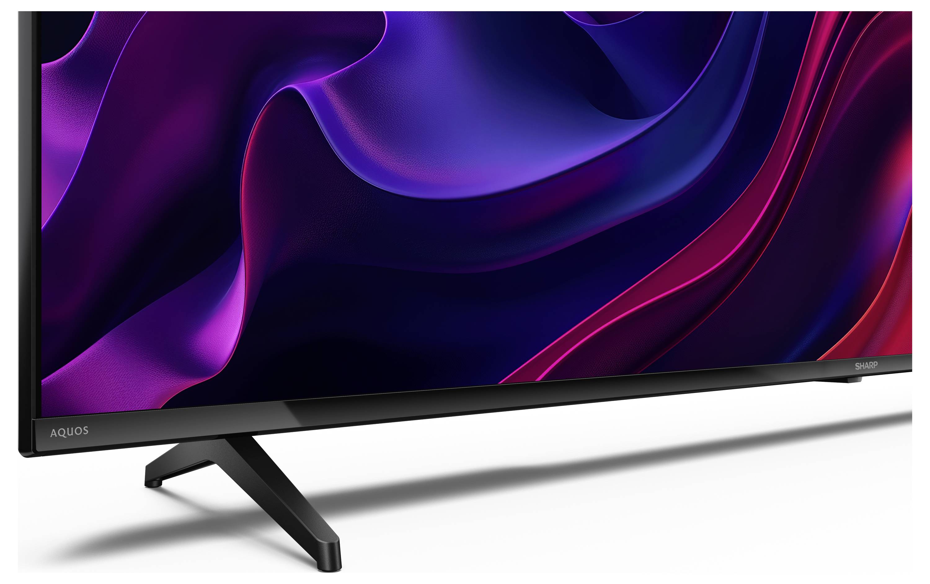 Un televisore elegante e moderno con un display astratto ondulato vibrante in viola e rosa, dotato di un solido supporto nero.