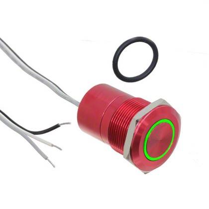Pulsante di commutazione in metallo rosso con anello LED verde e fili di connessione, mostrato accanto a un O-ring in gomma nera.