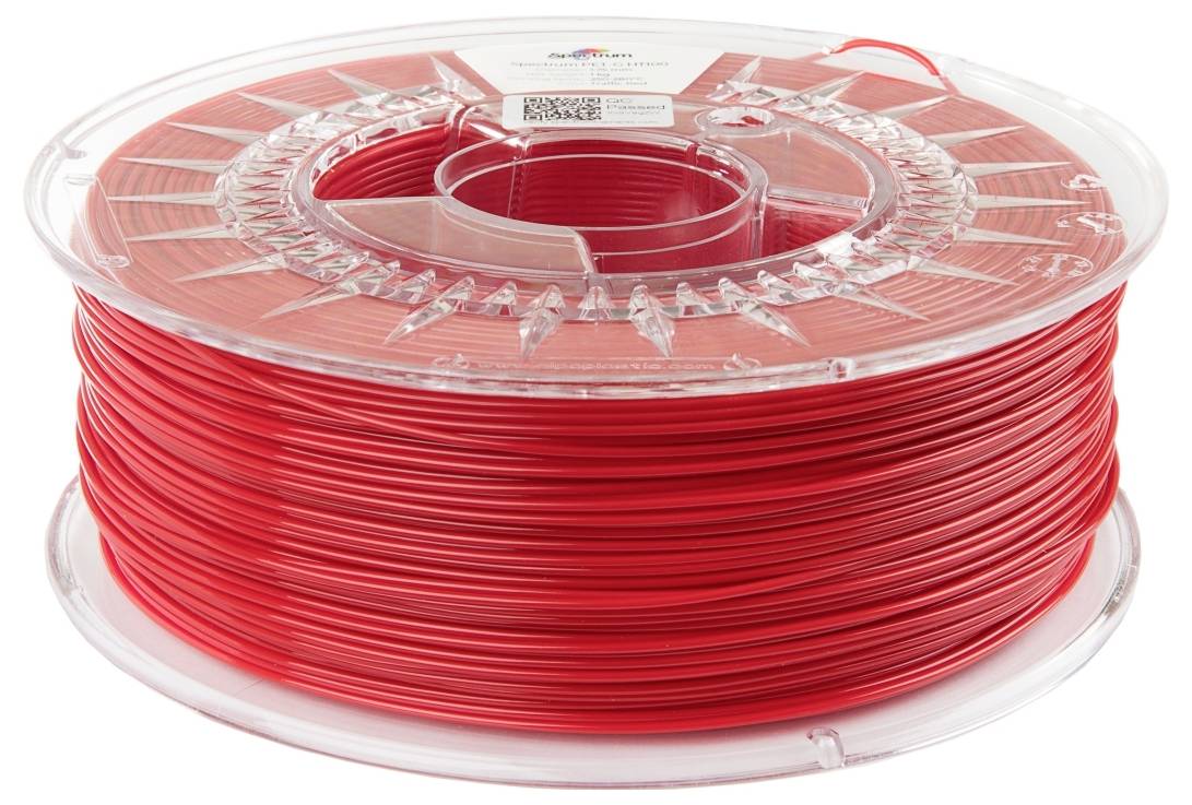 Un rocchetto di filamento per stampante 3D rosso, avvolto ordinatamente e contenuto all'interno di un contenitore di plastica trasparente e rotondo.