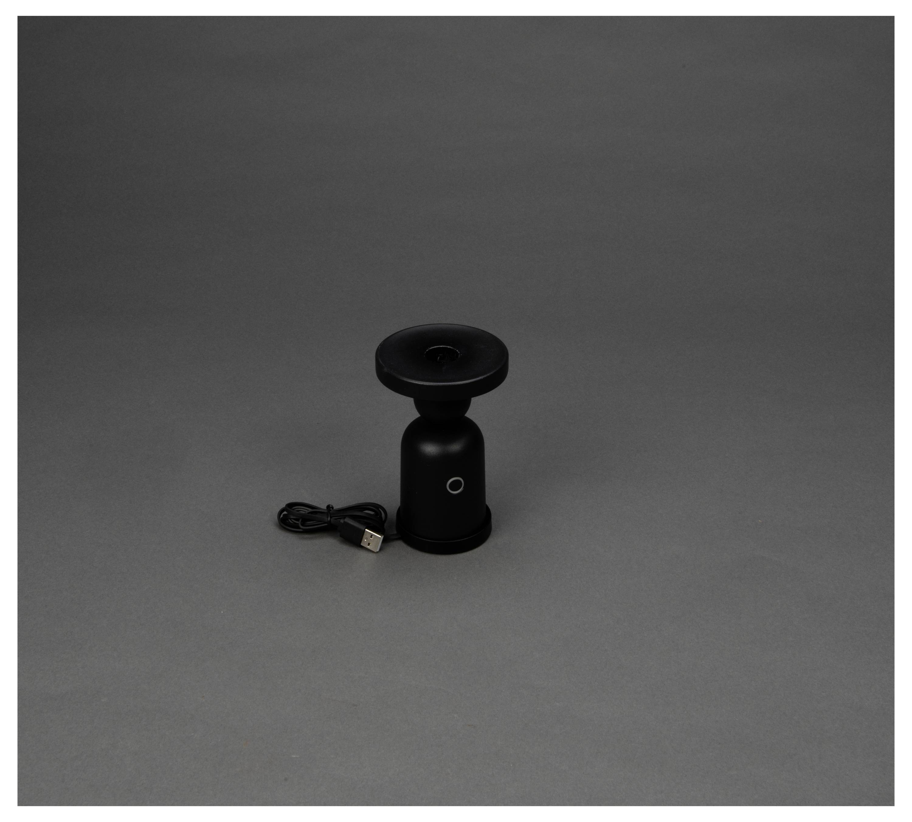 Un dispositivo nero compatto con una parte superiore circolare e un cavo USB, posizionato al centro di uno sfondo grigio, suggerisce un focus sul design minimalista.