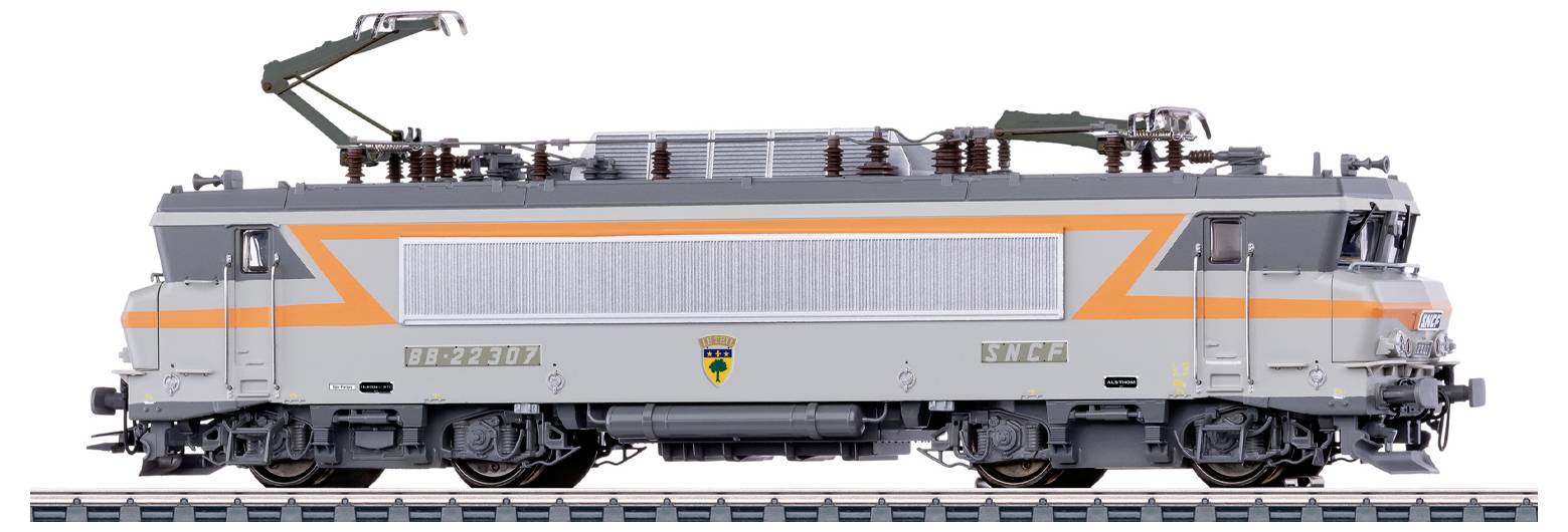 Un locomotore di un modello di treno con uno schema di colori grigio e arancione presenta attrezzature elettriche aeree su un binario.