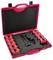 Un astuccio rosso con inserti in schiuma che contiene sette strumenti cilindrici rossi e neri e un utensile centrale con impugnatura.