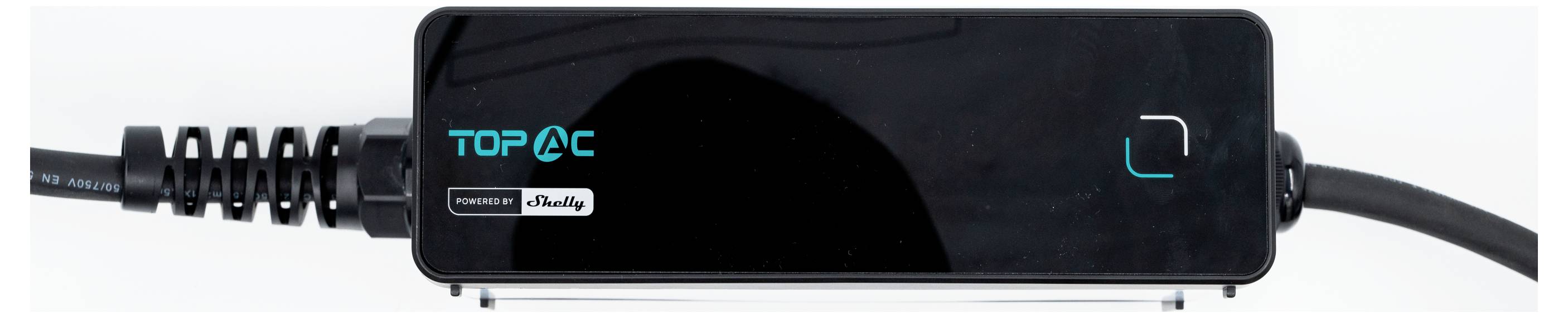 Un primo piano di un dispositivo nero 'TOP AC' con cavi collegati, che presenta un piccolo schermo e marchi di fabbrica.