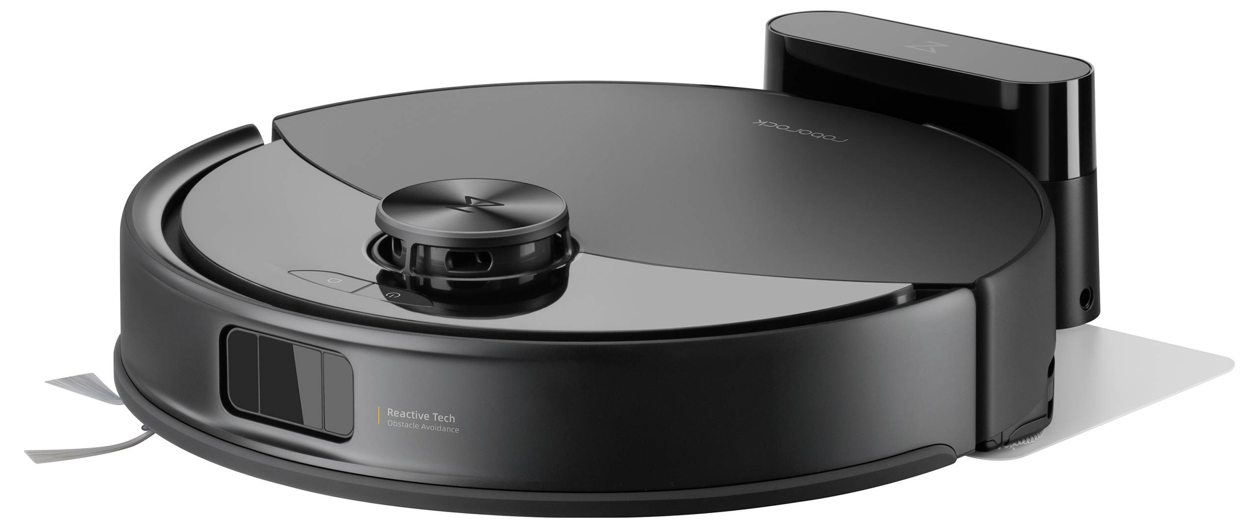 Un aspirapolvere robotico nero su una superficie bianca, con una base di ricarica dietro di esso. L'aspirapolvere ha una forma circolare e sensori sulla parte superiore.