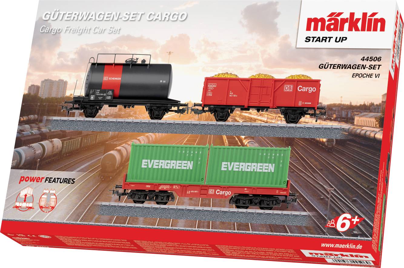 Set di modelli di treni in scatola raffigurante due vagoni merci, uno che trasporta contenitori di carico contrassegnati "Evergreen" e un altro vagone per materiali sfusi. Contrassegnato per età 6+.