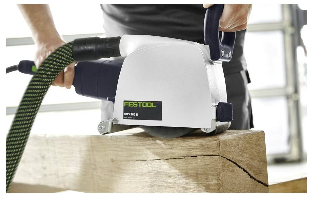 Una persona utilizza una pialla per legno Festool su una trave di legno, mostrando la lavorazione precisa e gli strumenti professionali di falegnameria.