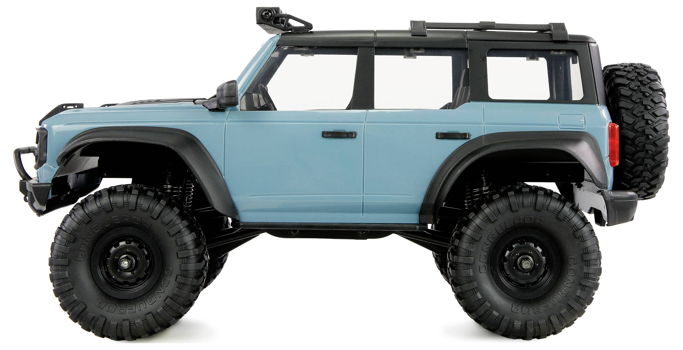 Un veicolo fuoristrada blu con pneumatici grandi e portapacchi sul tetto, visto di lato.