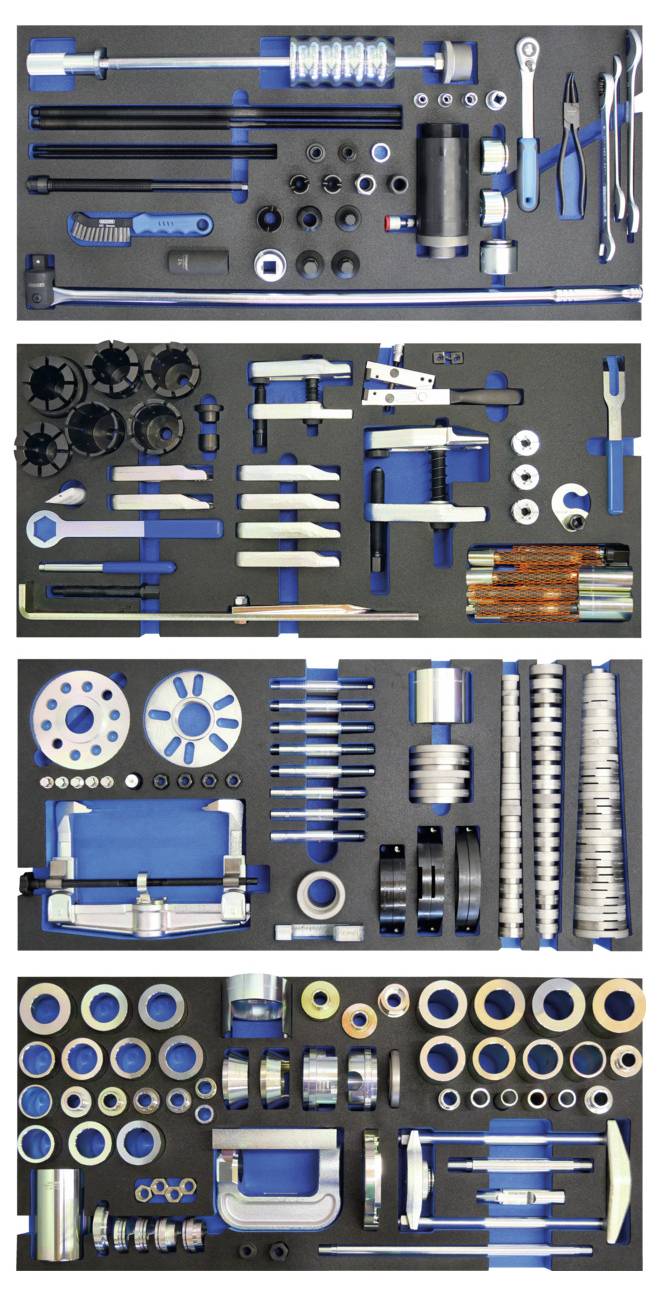 Un kit attrezzi ordinatamente organizzato con vari strumenti inclusi chiavi inglesi, cacciaviti, bussole e altri componenti hardware disposti su una superficie nera.