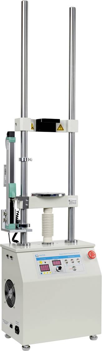 Una macchina di prova di laboratorio verticale con due alti pali di metallo, pannello di controllo con display digitale e una piattaforma centrale per gli esperimenti.
