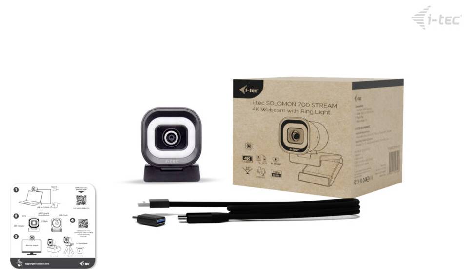 Una webcam con luce ad anello, confezione del prodotto, un cavo USB e una guida di istruzioni sono mostrati. Il logo del marchio "i-tec" è visibile sulla scatola.