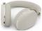 Cuffie wireless over-ear beige con fascia per la testa rivestita in tessuto, controlli on-ear e porta di ricarica USB-C mostrate su sfondo bianco.