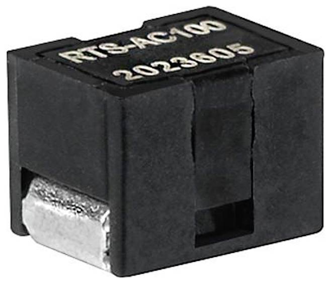 Componente 'RTS-AC100 2023605', probabilmente un modulo elettrico, con involucro nero, piccolo connettore metallico visibile sul lato.