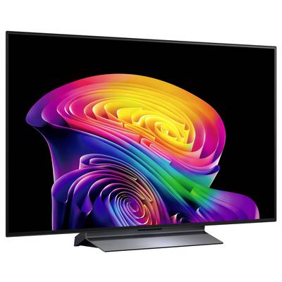 Una TV a schermo piatto che mostra un vivace turbine arcobaleno astratto su uno sfondo nero.