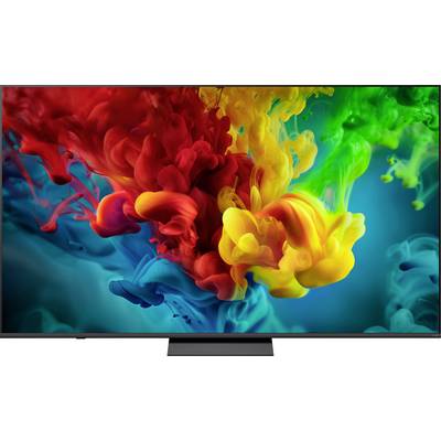 Immagine astratta di nuvole di inchiostro rosso, giallo, verde e blu vibranti che turbinano nell'acqua su uno schermo televisivo.