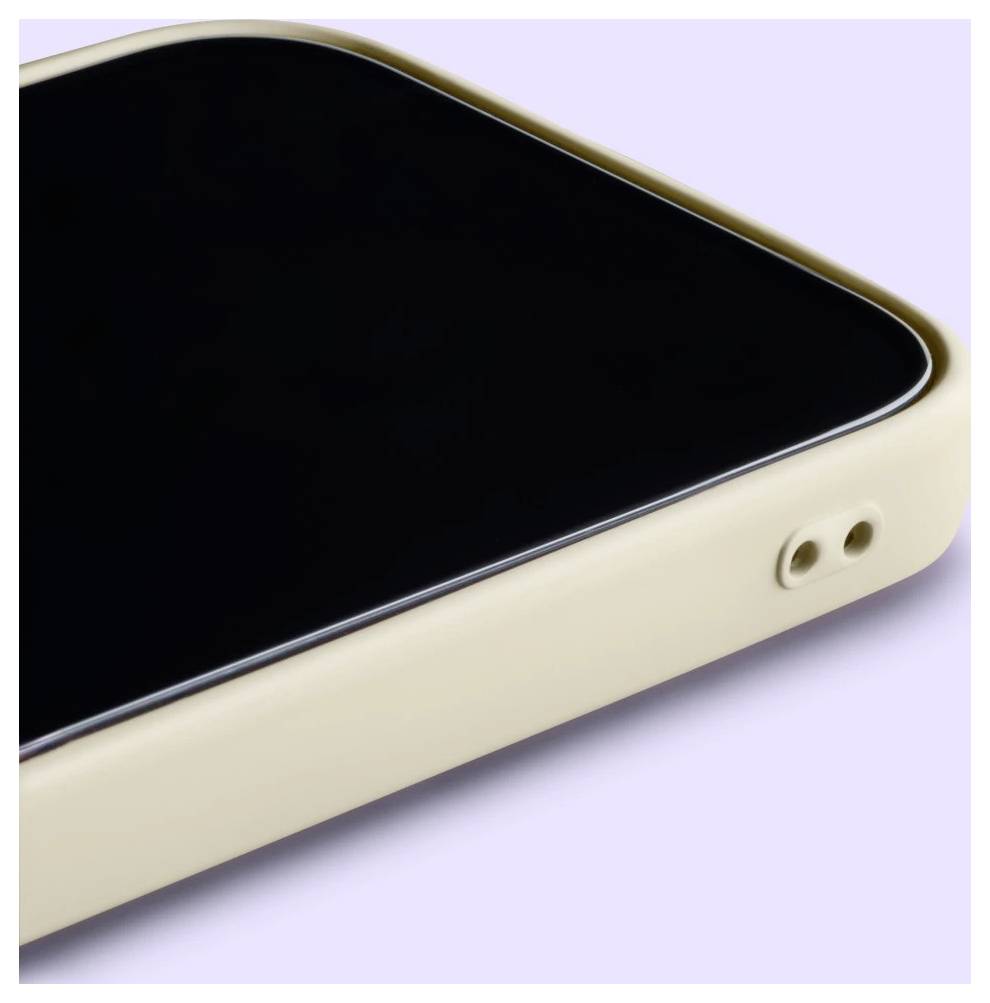 Primo piano dell'angolo di uno smartphone beige con schermo nero e due aperture laterali su uno sfondo viola chiaro.