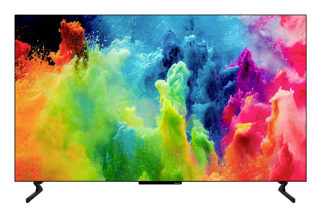 TV a schermo piatto che visualizza un vivido scoppio astratto di nuvole di polvere multicolore, con piedini del supporto neri su sfondo bianco.