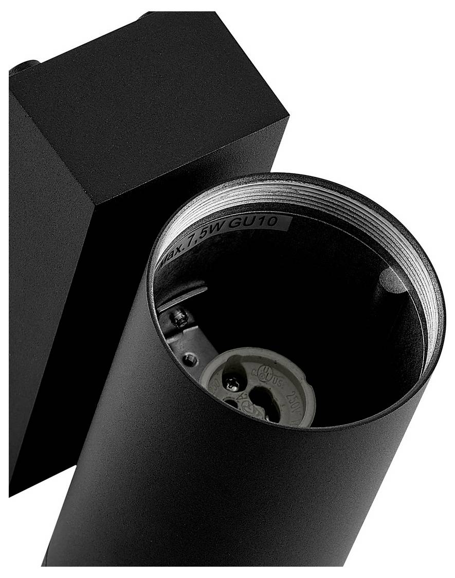 Primo piano di un apparecchio di illuminazione cilindrico nero che mostra un socket per lampadina GU10 aperto all'interno di una staffa quadrata.