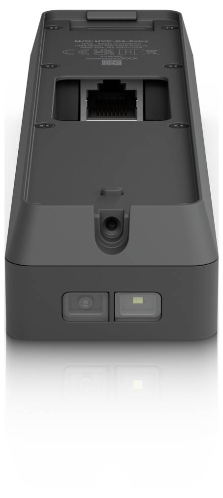 Vista posteriore di un dispositivo elettronico grigio scuro che mostra una porta Ethernet, un pulsante di accensione e una spia di stato sul bordo inferiore.