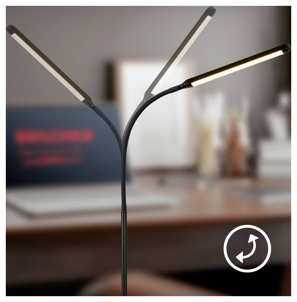 Lampada da scrivania LED a tre bracci regolabili su una scrivania, con area di lavoro sfocata sullo sfondo e un'icona di rotazione circolare in basso a destra.