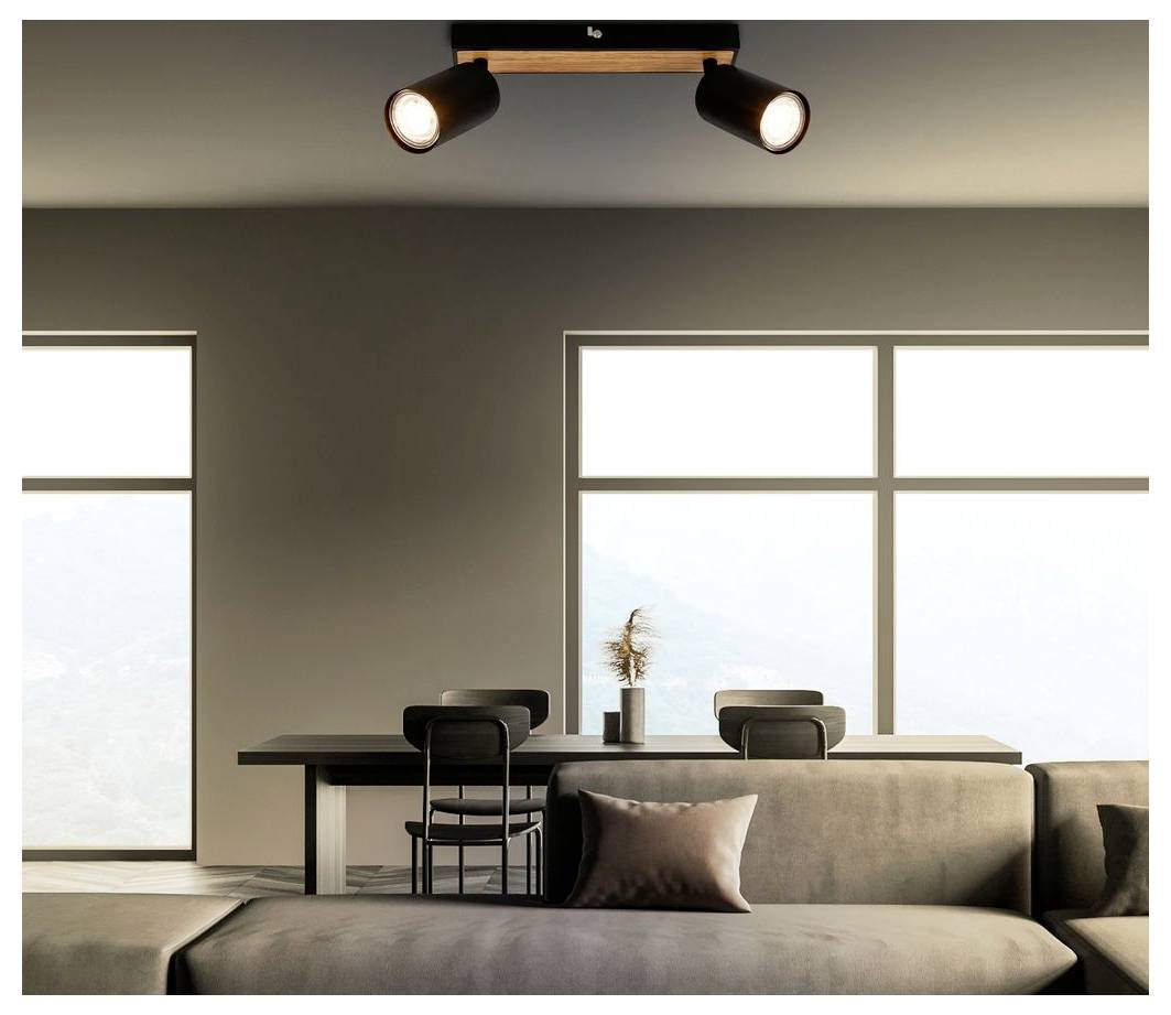 Soggiorno minimalista moderno con divano, scrivania e sedia, ampi finestre e faretti da soffitto.