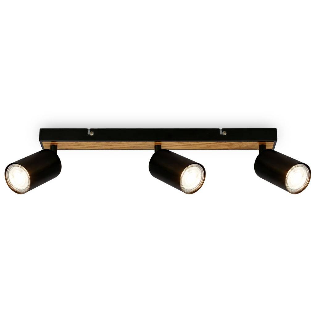Plafoniera nera a tre luci con lampade cilindriche regolabili su barra con accenti in legno.