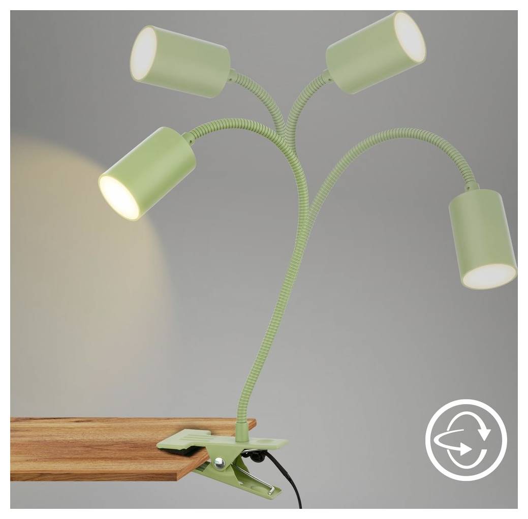 Lampada da tavolo verde con quattro teste, clip-on con braccia pieghevoli fissata a un tavolo di legno, due luci accese, una spenta.