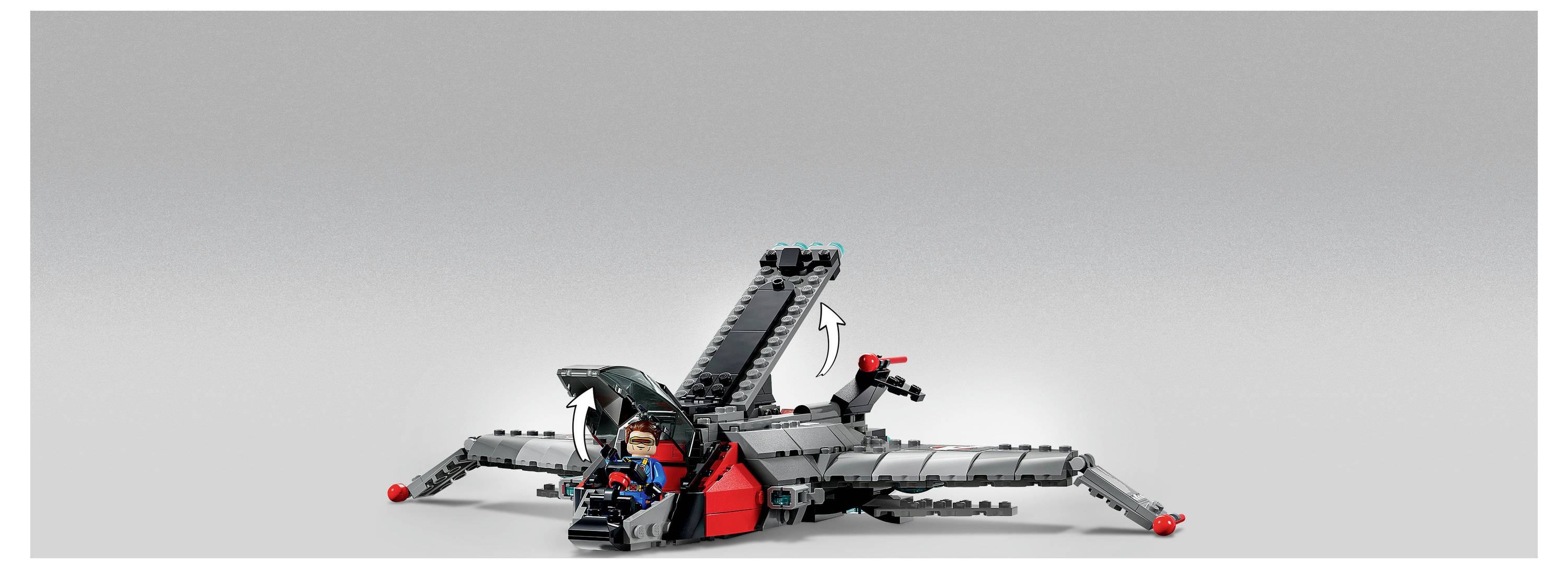 Un robot ragno simile a LEGO con zampe grigie e accenti rossi siede su uno sfondo chiaro e uniforme, con un pilota seduto al centro e un braccio posteriore sollevato.