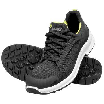 Scarpa da sicurezza atletica nera bassa con suola bianca e accenti giallo neon, mostrata con la suola esterna visibile.