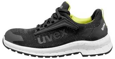 Scarpa atletica nera e grigia con suola bianca e fodera giallo neon, mostrata in vista laterale su sfondo bianco.