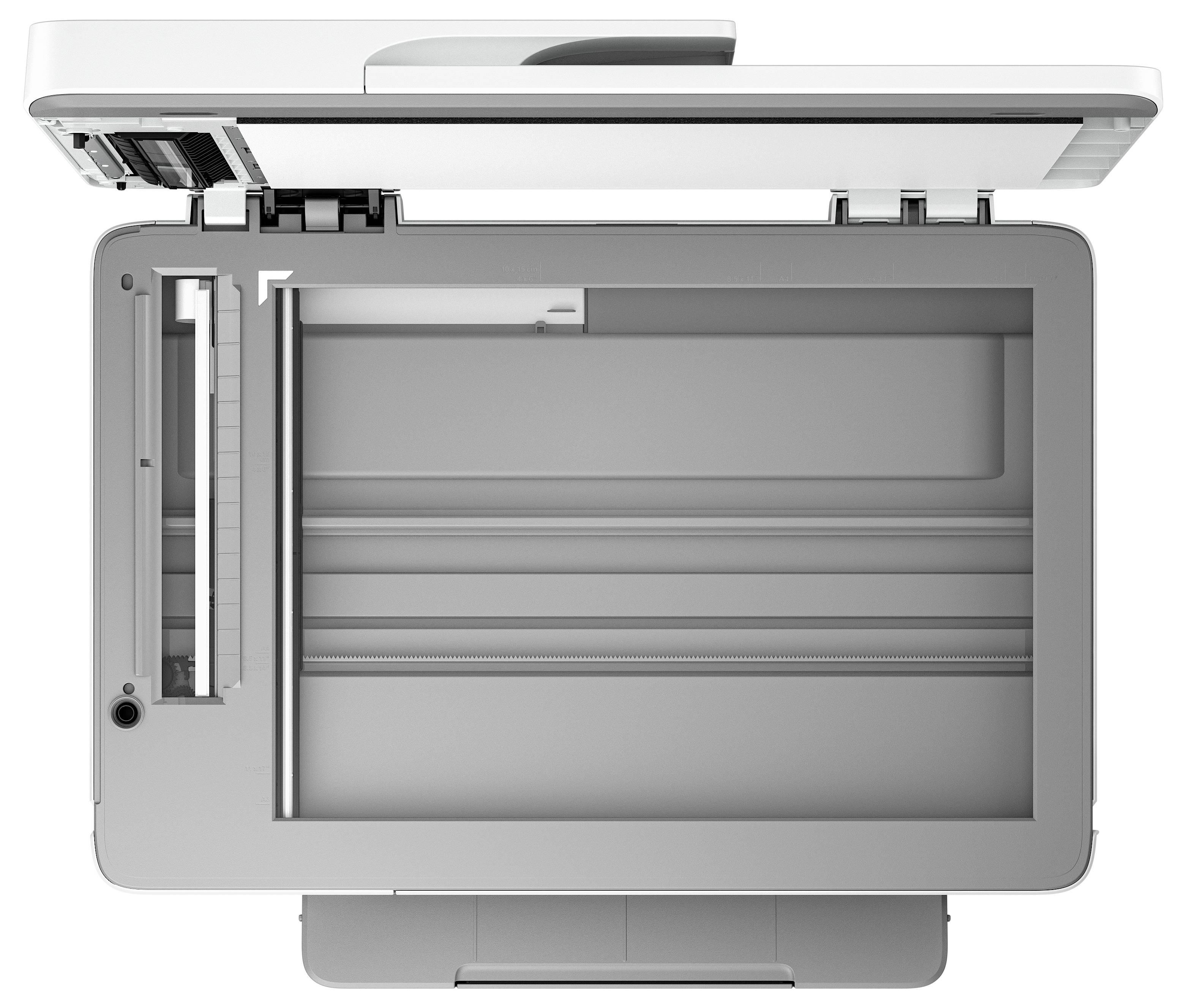 Vista dall'alto di uno scanner pianale o di una fotocopiatrice con il coperchio aperto, che mostra il letto di scansione in vetro e l'area del documento.