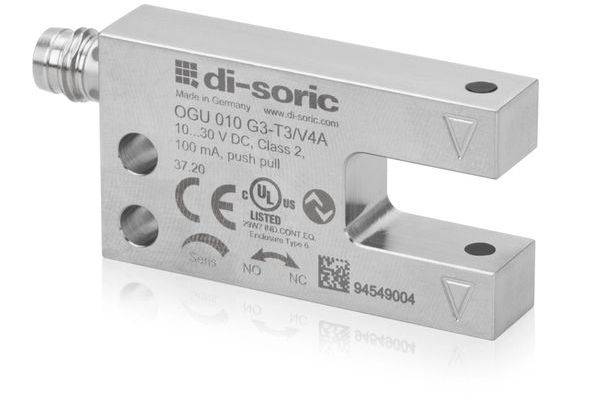 Un sensore industriale di-sorico in argento con slot a forma di U, etichettato 'OGU 010 G3-T3/V4A' e marchi di certificazione, mostrato su sfondo bianco.