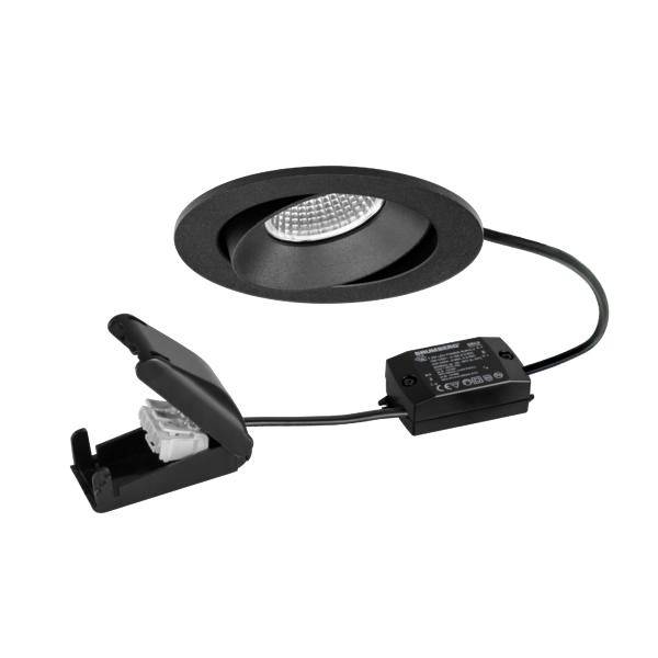 Kit di faretti LED incassati neri con trim rotondo, driver cablato e supporto con clip a molla mostrato su sfondo bianco