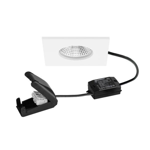 Kit di faretti LED incassati bianchi con cornice, scatola del trasformatore e clip a molla su cavo, mostrato su sfondo bianco.