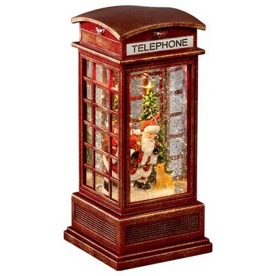 Lanterna natalizia a forma di cabina telefonica rossa con una figurina di Babbo Natale e un albero decorato all'interno, illuminata come una decorazione festiva.