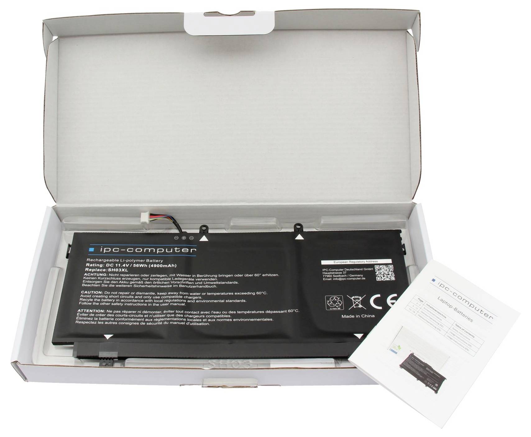 Scatola aperta contenente una batteria di ricambio per computer IPC, con foglio di istruzioni accanto.