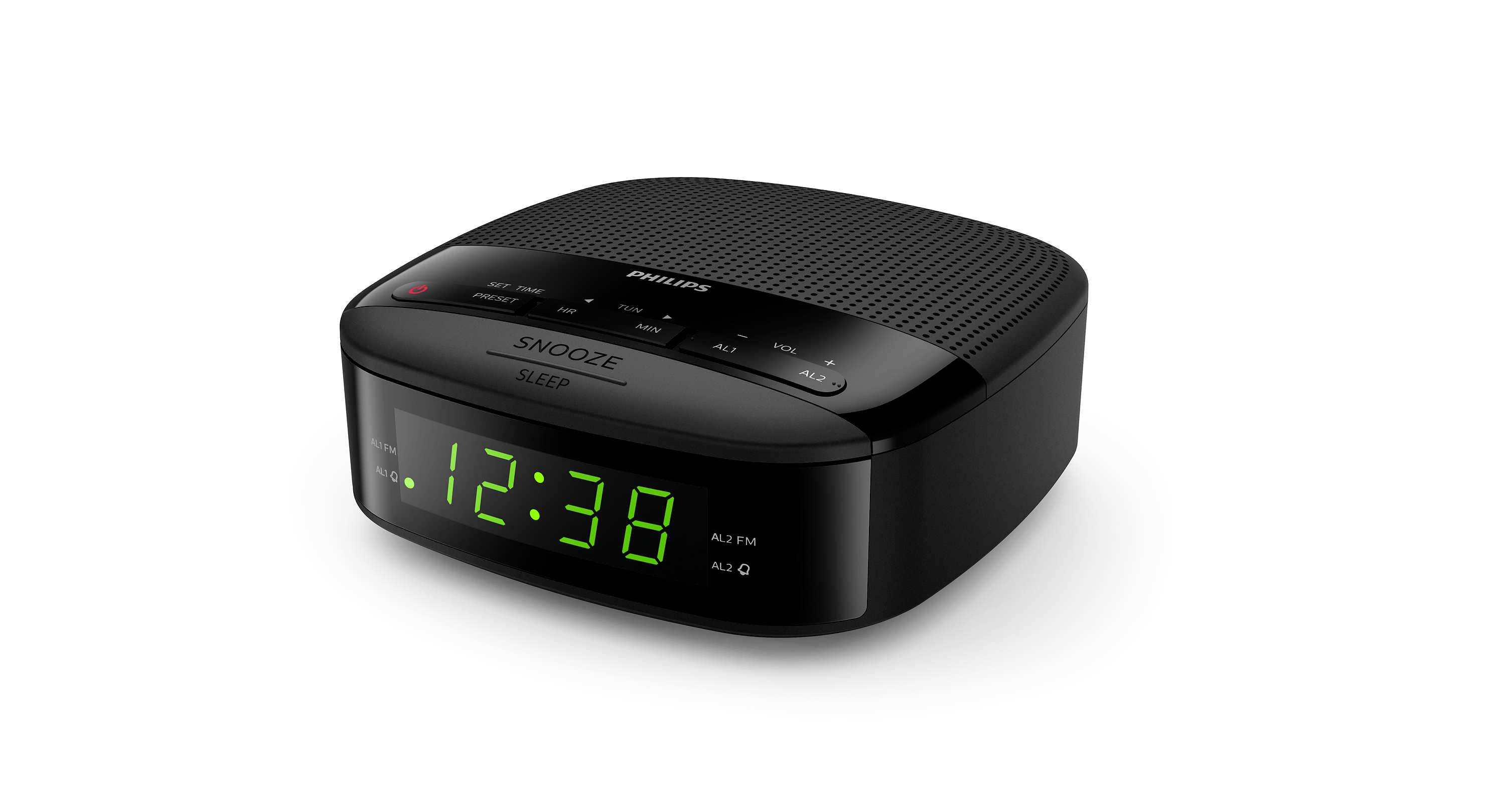Sveglia radio digitale nera con display che mostra le 12:38 in cifre LED verdi e comandi per la funzione snooze e la radio sulla parte superiore.