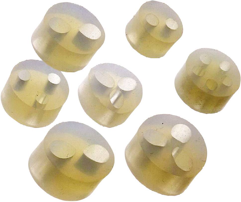 Diversi tappi in silicone marrone chiaro, rotondi, con due, tre o quattro concave cavità su una superficie bianca.