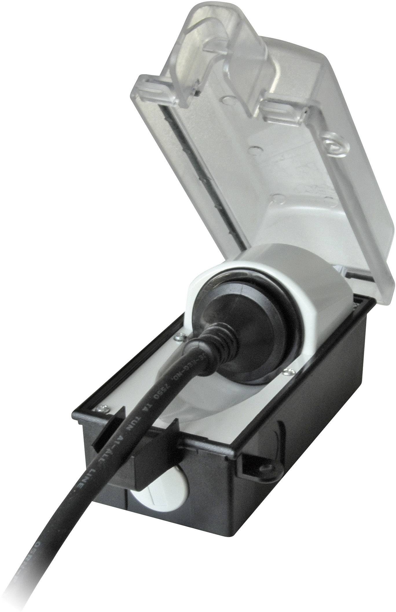 Un involucro nero con un coperchio trasparente aperto, all'interno del quale è inserita una spina elettrica con cavo.