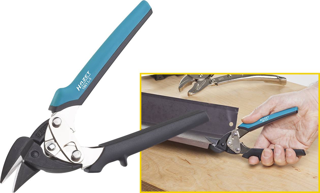 Un paio di forbici per lamiera con impugnatura blu e nera taglia un foglio di metallo. L'utensile è poggiato su un tavolo di legno.