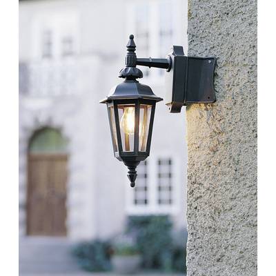 'Lanterna da esterno in metallo nero con design classico, fissata a un muro di pietra, illumina un ingresso con porta in legno.'