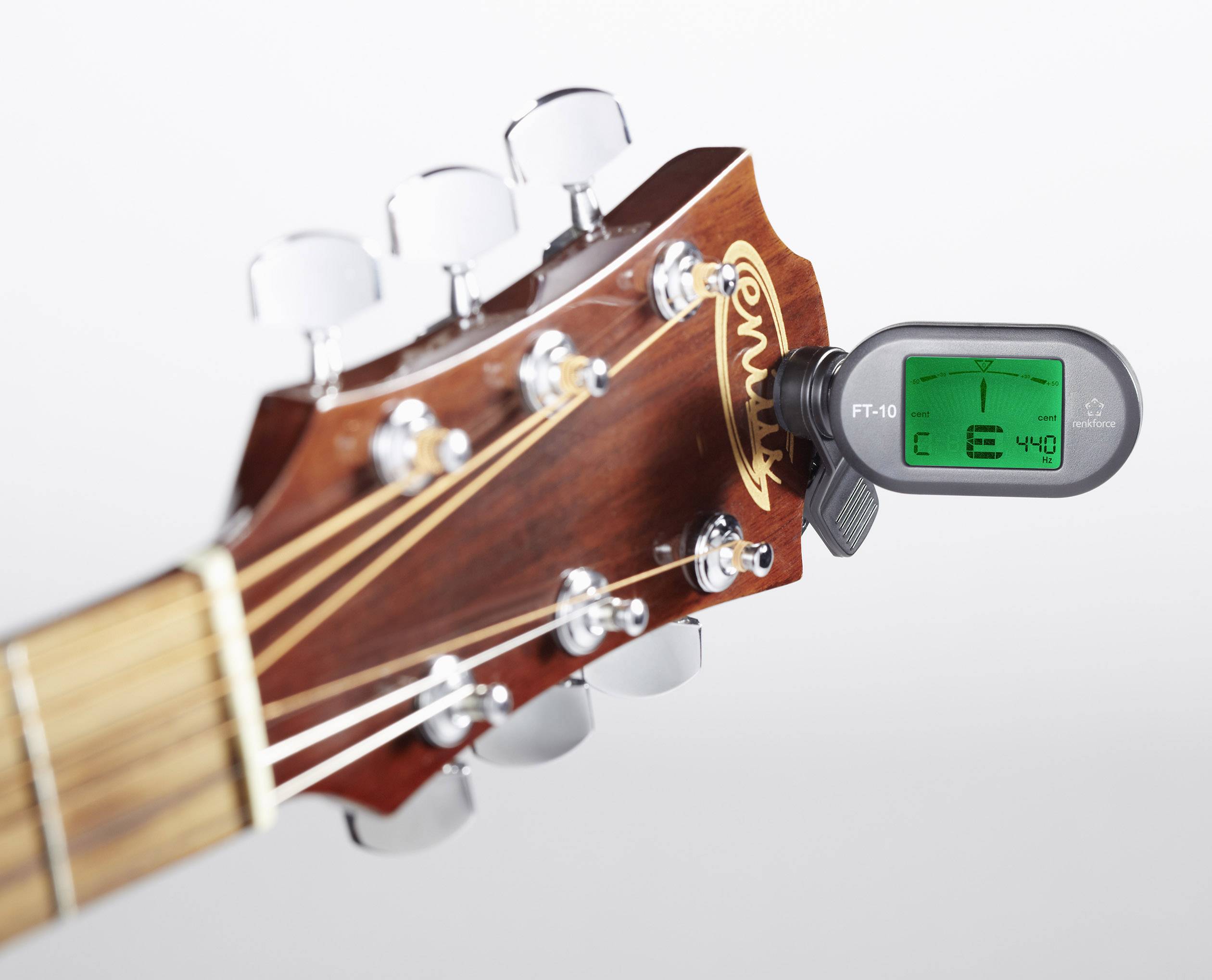Una paletta della chitarra con un accordatore elettronico montato che indica il tono E-440.
