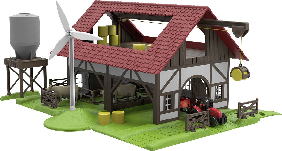 Modello di un'azienda agricola con tetto rosso, mulino a vento, silos, trattore e balle di fieno. Pecore nel recinto. Rappresentazione di un'agricoltura sostenibile.