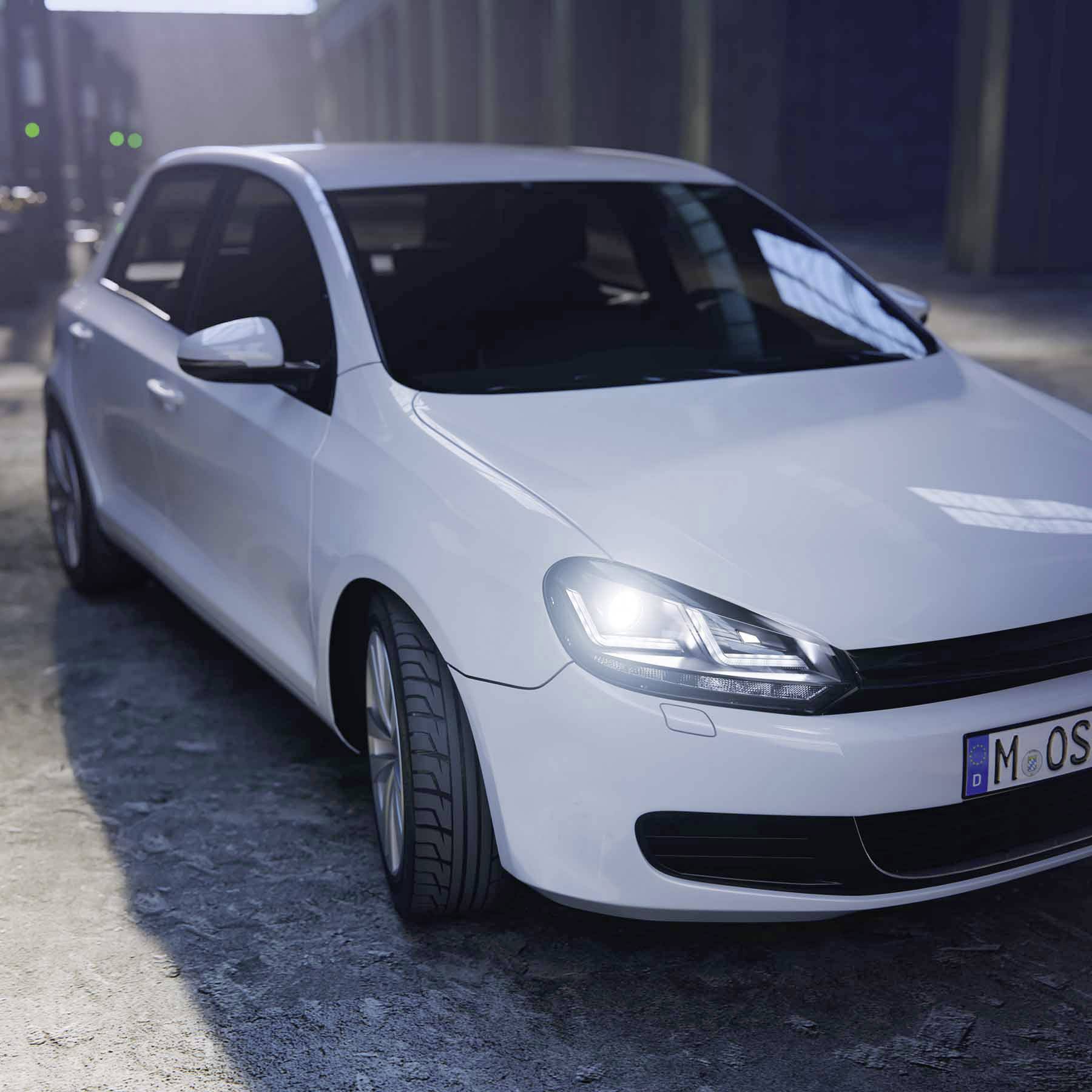Un'auto bianca è parcheggiata su un pavimento in cemento all'interno di un capannone. Una luce diffusa illumina il cofano dall'alto, mentre lo sfondo è sfocato.