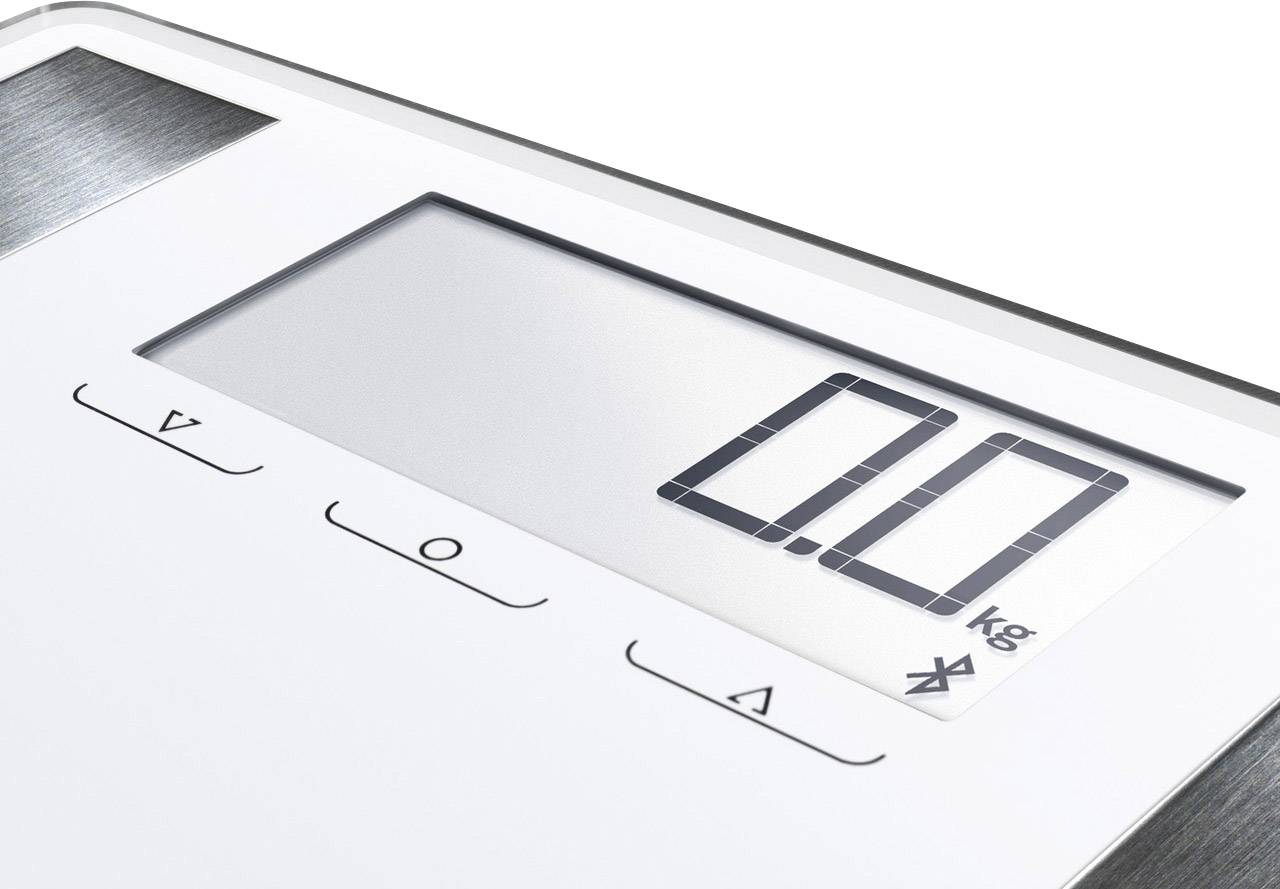 Bilancia elettronica con display digitale che mostra '0,0 kg'. Pulsanti di controllo sotto lo schermo. Il bordo argentato suggerisce un design moderno.