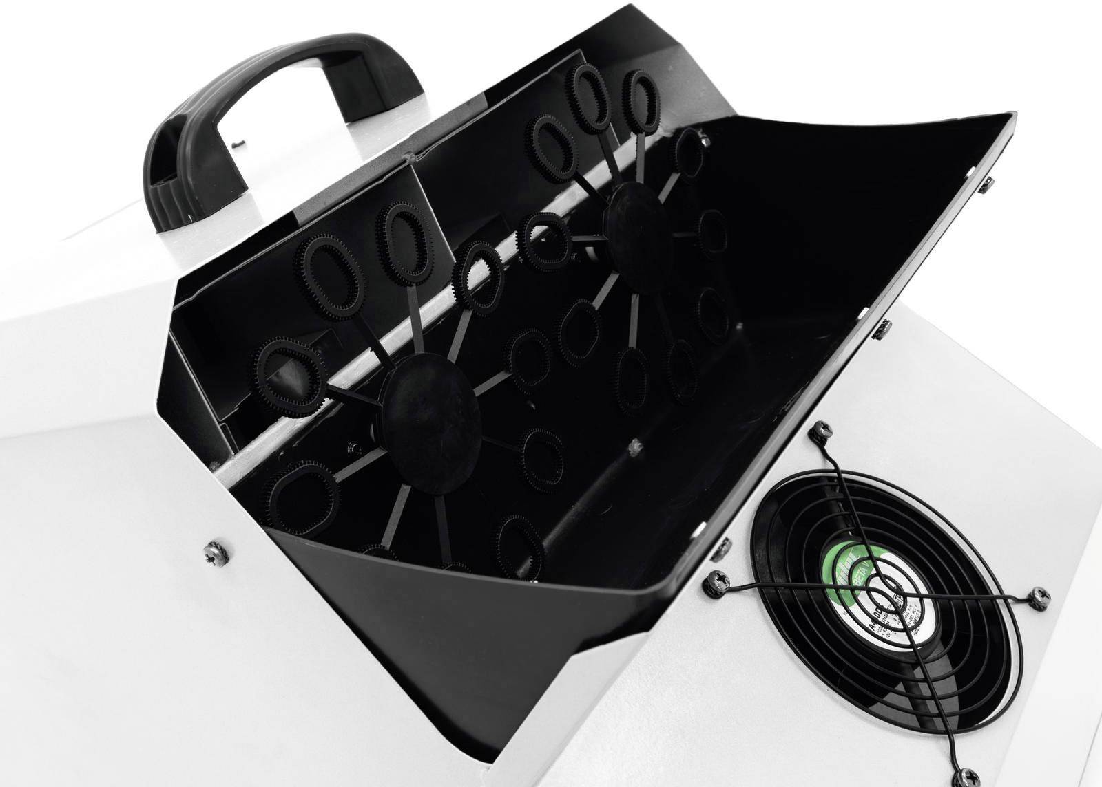 Un dispositivo bianco con un manico nero e un coperchio aperto che mostra diversi supporti rotondi. Sotto, un ventilatore con luce verde.
