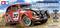 Un'auto giocattolo rossa in stile rally con il numero 217 sul lato. Sullo sfondo il logo Tamiya e la scritta 'Volkswagen Beetle Rally'.