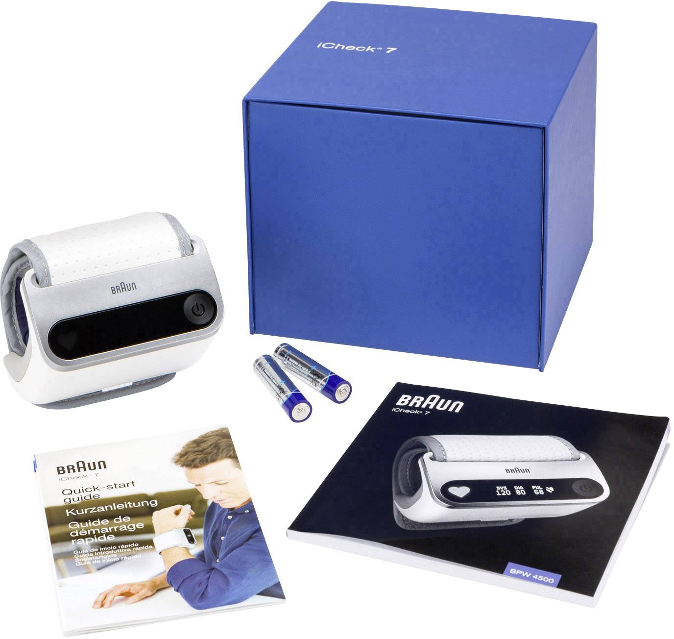 Un misuratore di pressione sanguigna Braun con confezione, due batterie, un breve manuale di istruzioni e un manuale utente su un tavolo.