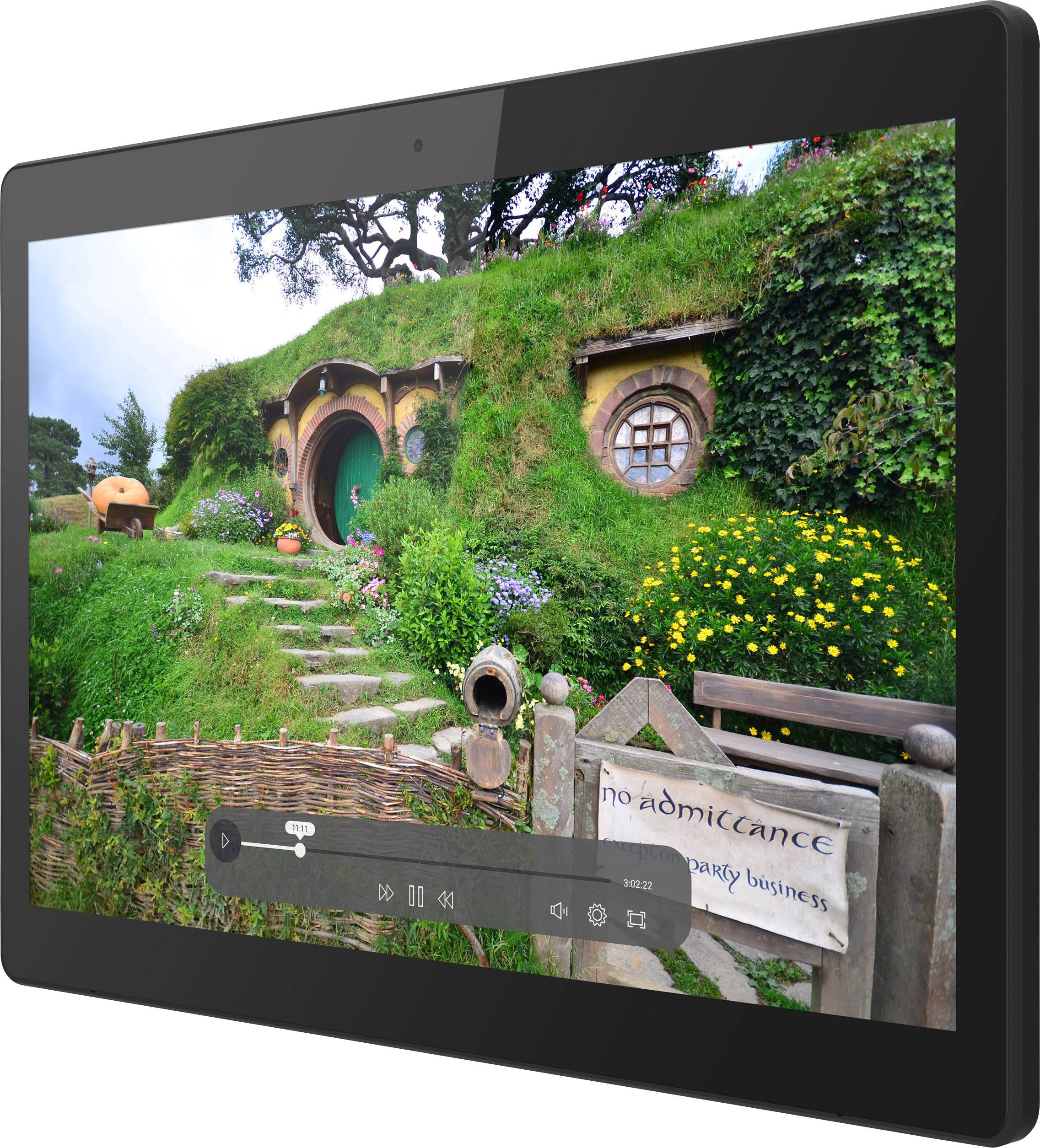 Una casa degli Hobbit ricoperta di verde in un paesaggio collinare, con un telaio della porta rotondo e piccole finestre; un ambiente idilliaco e fiabesco.